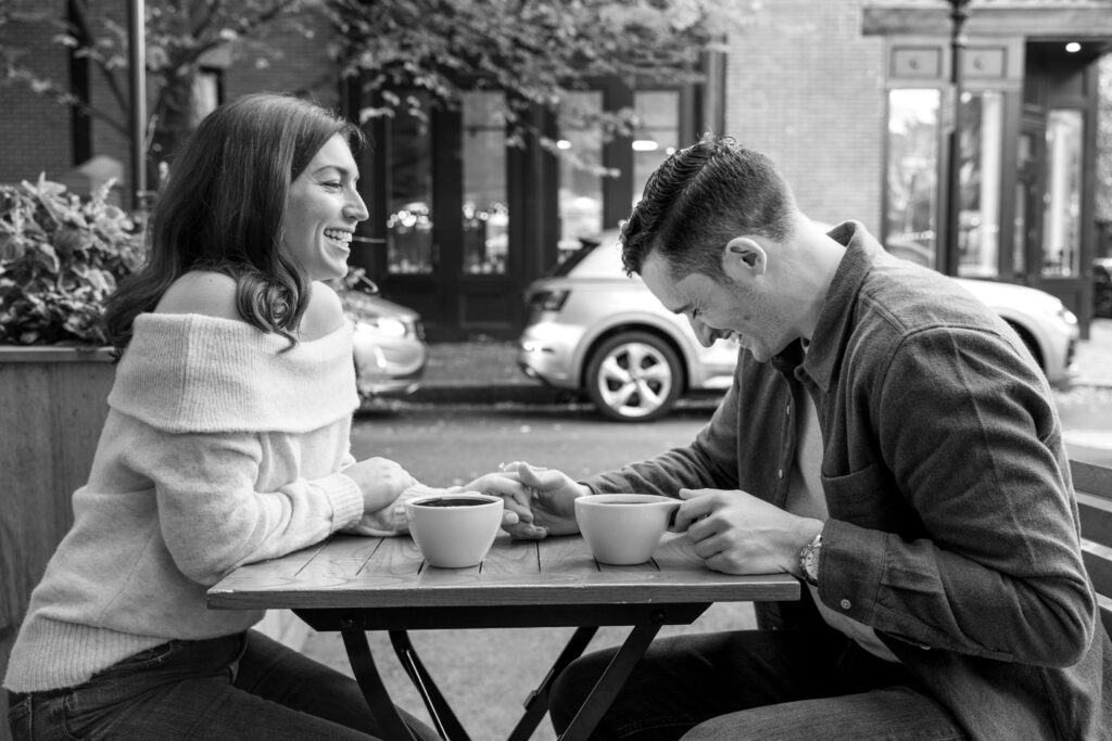 couple laughs outside South End Buttery during Boston engagement photos