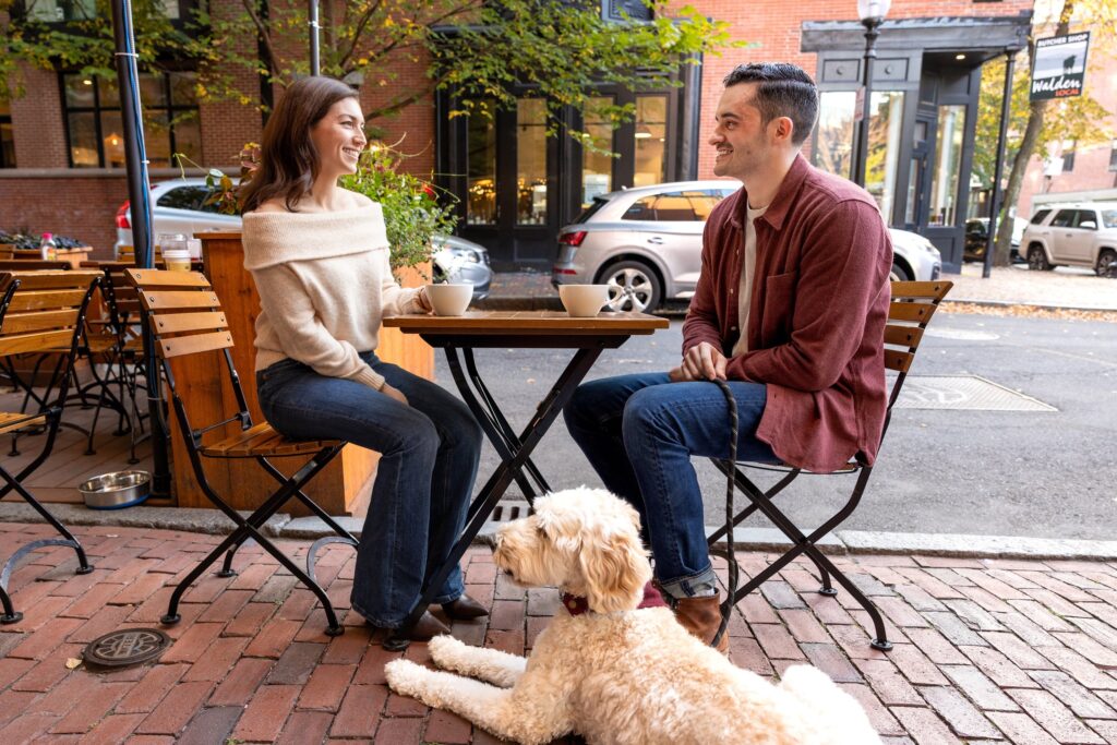 couple laughs outside South End Buttery during Boston engagement photos
