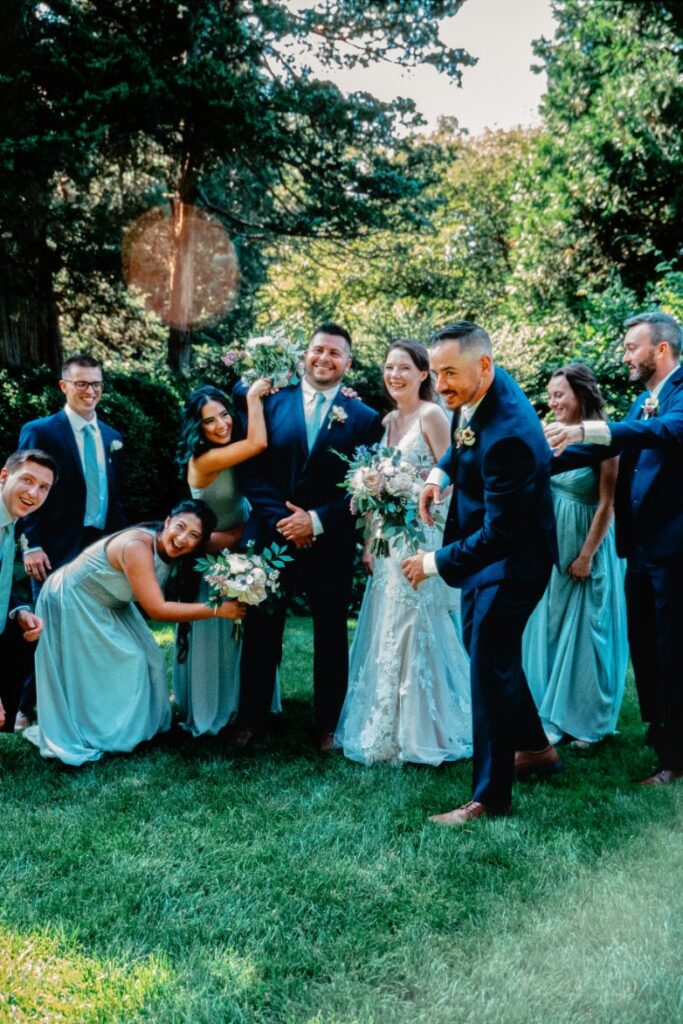 Candid wedding party photo at Long Hill with natural light and vintage lens flare, captured on film by wedding film photographer