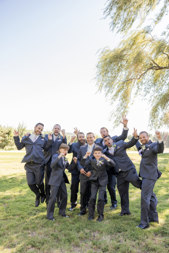 Candid portrait of groomsmen and the ring bearers with the groom