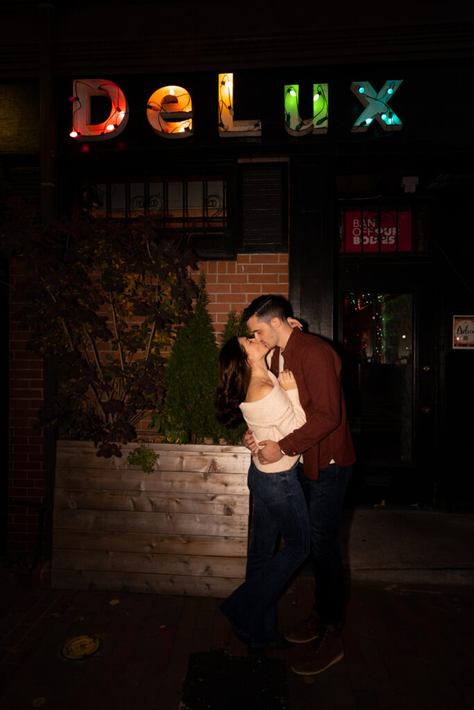 couple kisses outside of Delux cafe in South End Boston