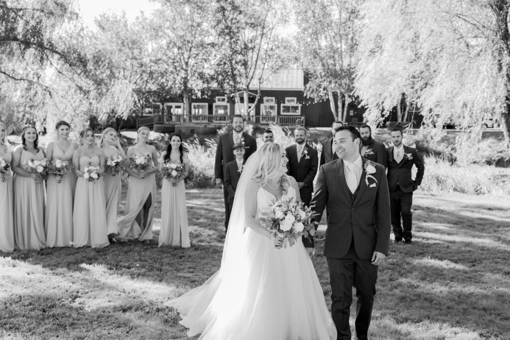 Candid portraits of bride and groom with their wedding party in black and white