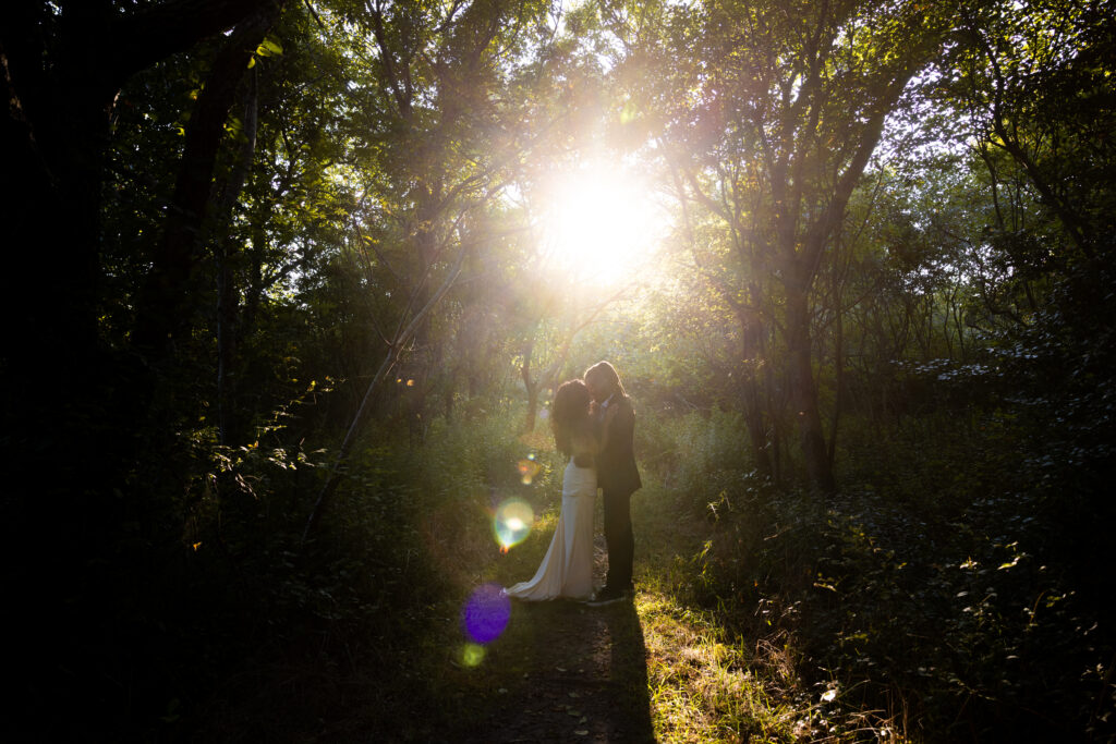 Couple elopes on Block Island Sun flare in the woods