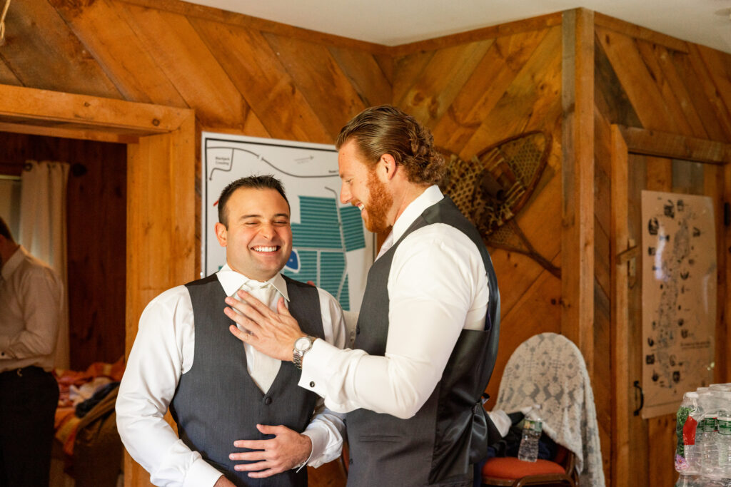 Groom joking around with his best man in as they get ready