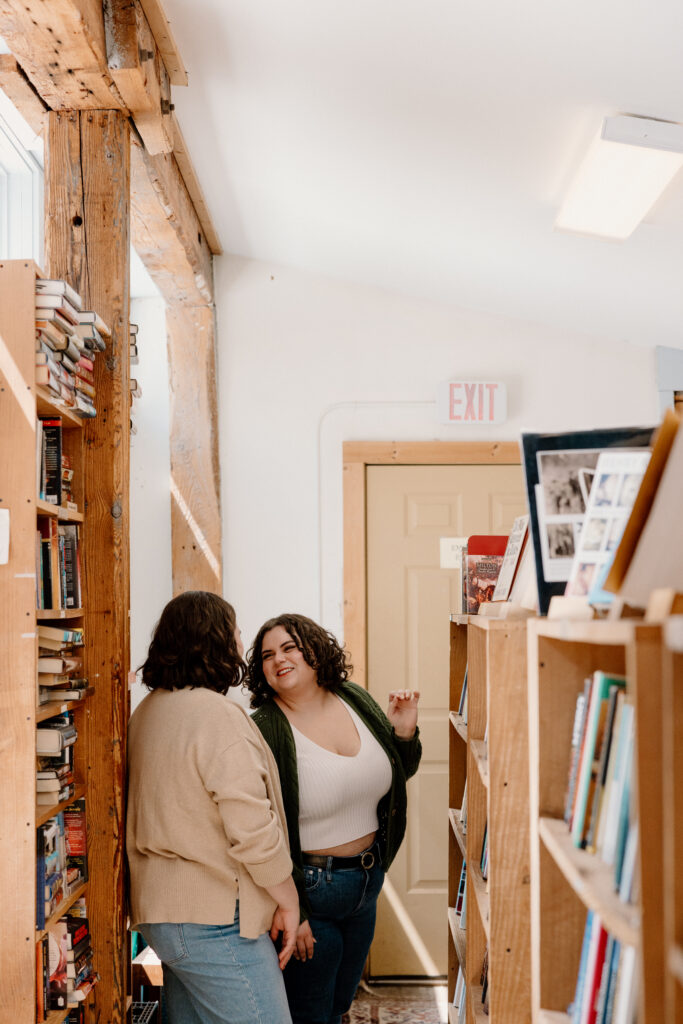 lesbian couple in bookstore during engagement photoshoot