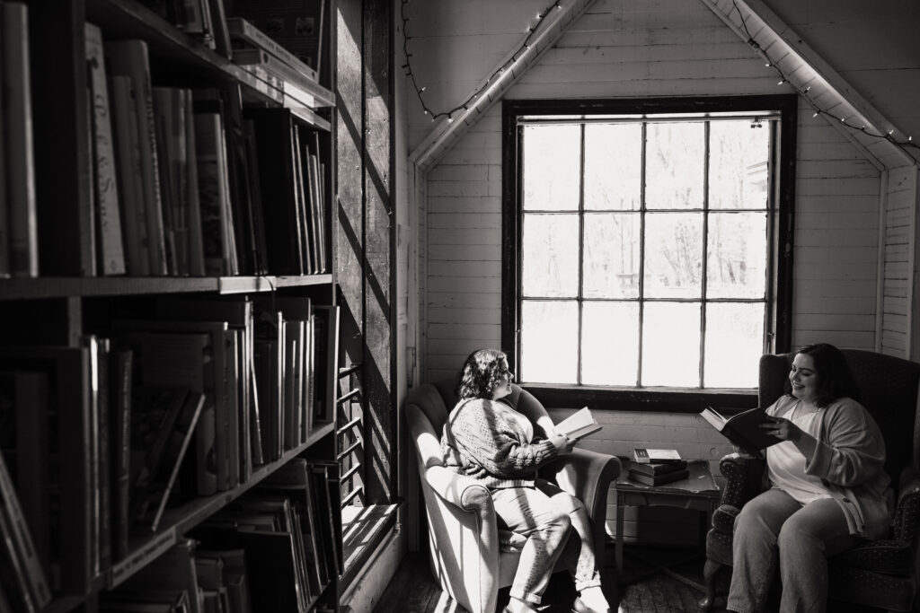 lesbian couples read during engagement photoshoot at The Montague Bookmill