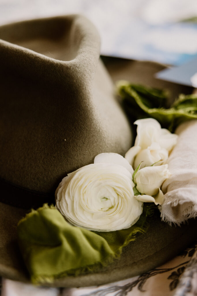 Groom's Cowboy Hat detail photo with decorative flowers