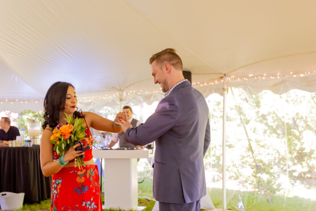 The bride and groom exchange rings at their ceremony at the Loring-Greenough House
