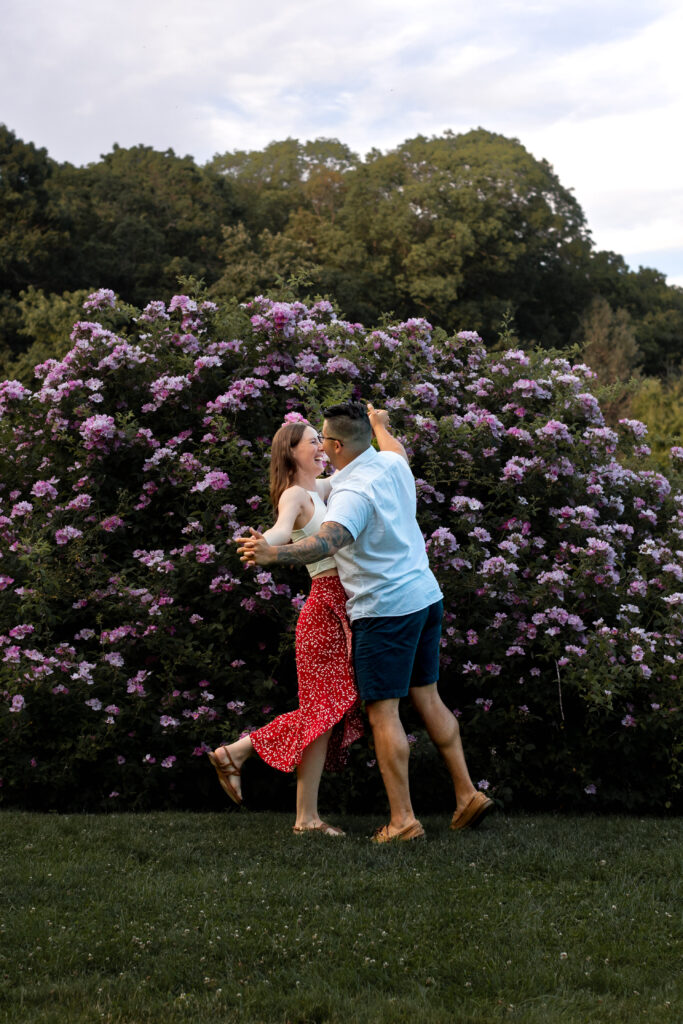 Engaged couple session at the Arnold Arboretum. Diverse Couple, engaged mixed couple, Candid moments of the couple dancing together in the rose garden