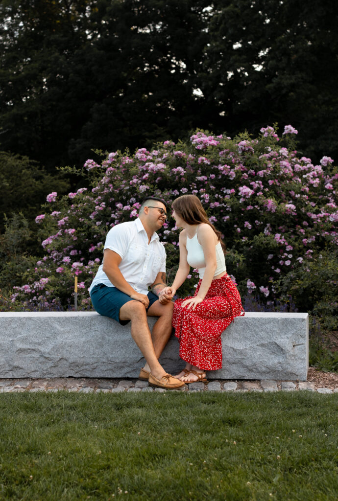 Engaged couple session at the Arnold Arboretum. Diverse Couple, engaged mixed couple, Candid moments of the couple sitting on bench