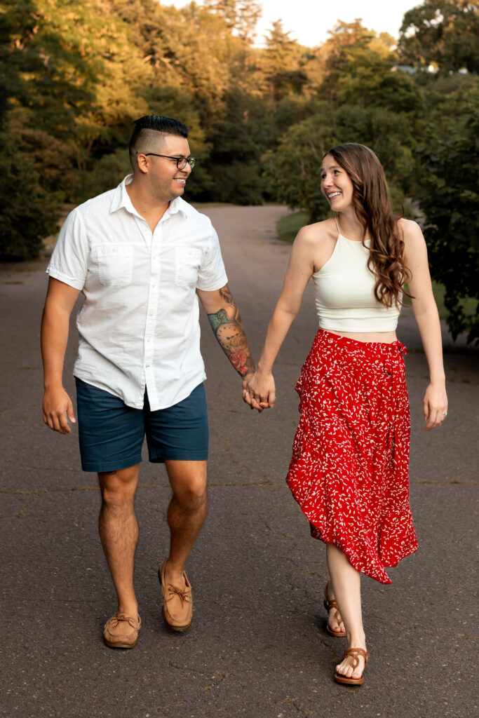 Engaged couple session at the Arnold Arboretum. Diverse Couple, engaged mixed couple, Candid moments of the couple walking together holding hands