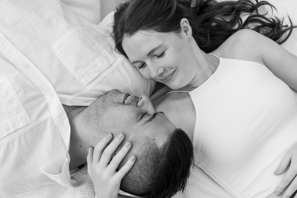 Engaged couple session at the Arnold Arboretum. Diverse Couple, engaged mixed couple, Candid moments of the couple overhead photo of them laying down on a blanket In black and white