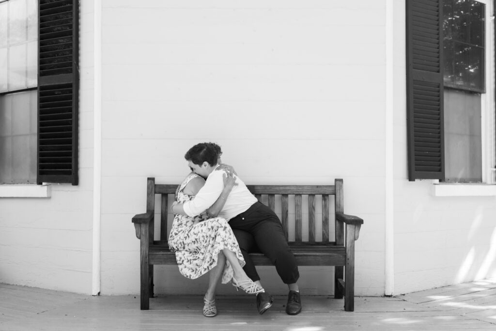 LGBTQIA+ couple elopes. Candid Wedding Family Portraits, Mother and daughter hug each other in black and white