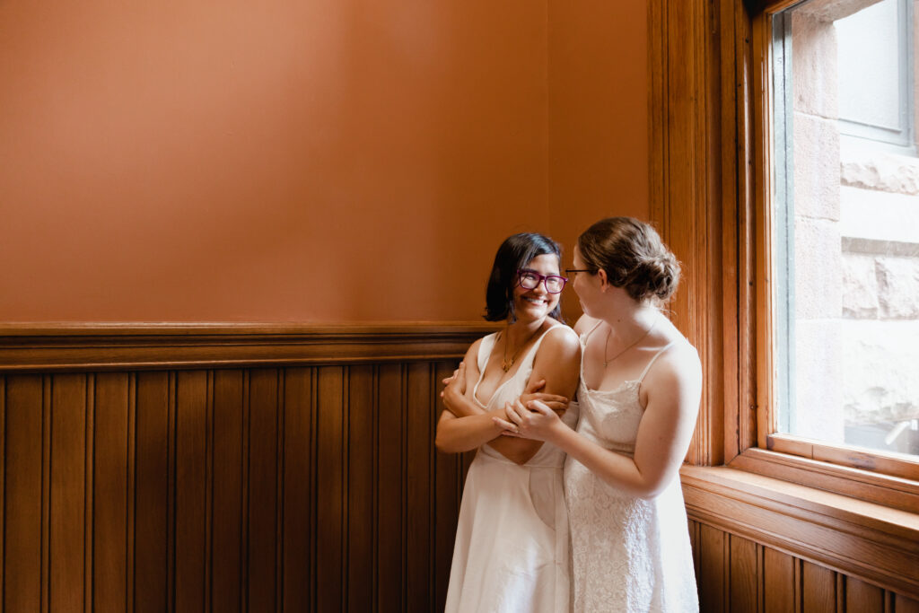 lesbian couple kisses at Cambridge City Hall wedding
