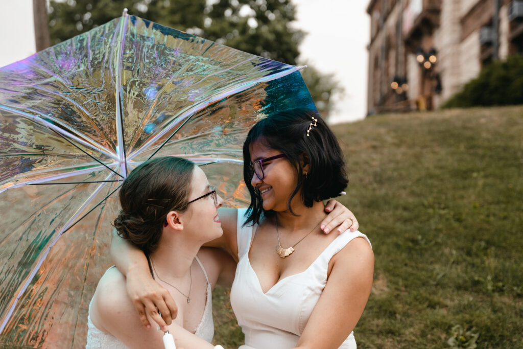 lesbian couple posed for photos outside of Cambridge City Hall wedding