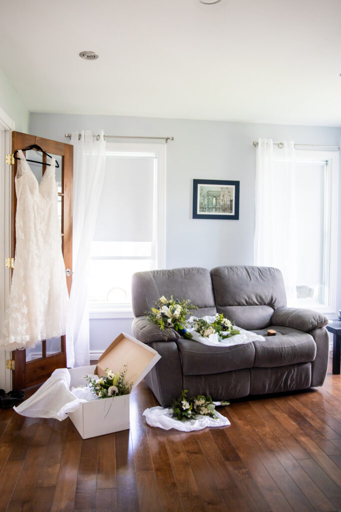 Wedding Bouquets were scattered around the living room, Wedding dress hanging on the door.