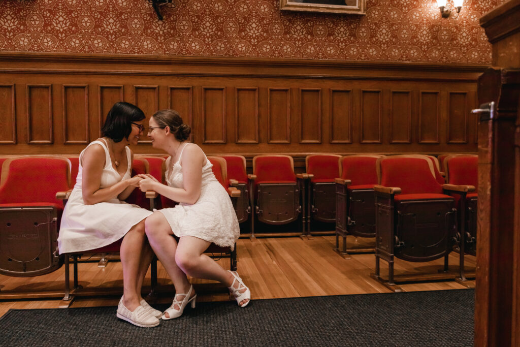 same sex couple poses for photos after Cambridge City Hall wedding