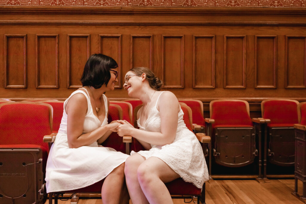 same sex couple poses for photos after Cambridge City Hall wedding