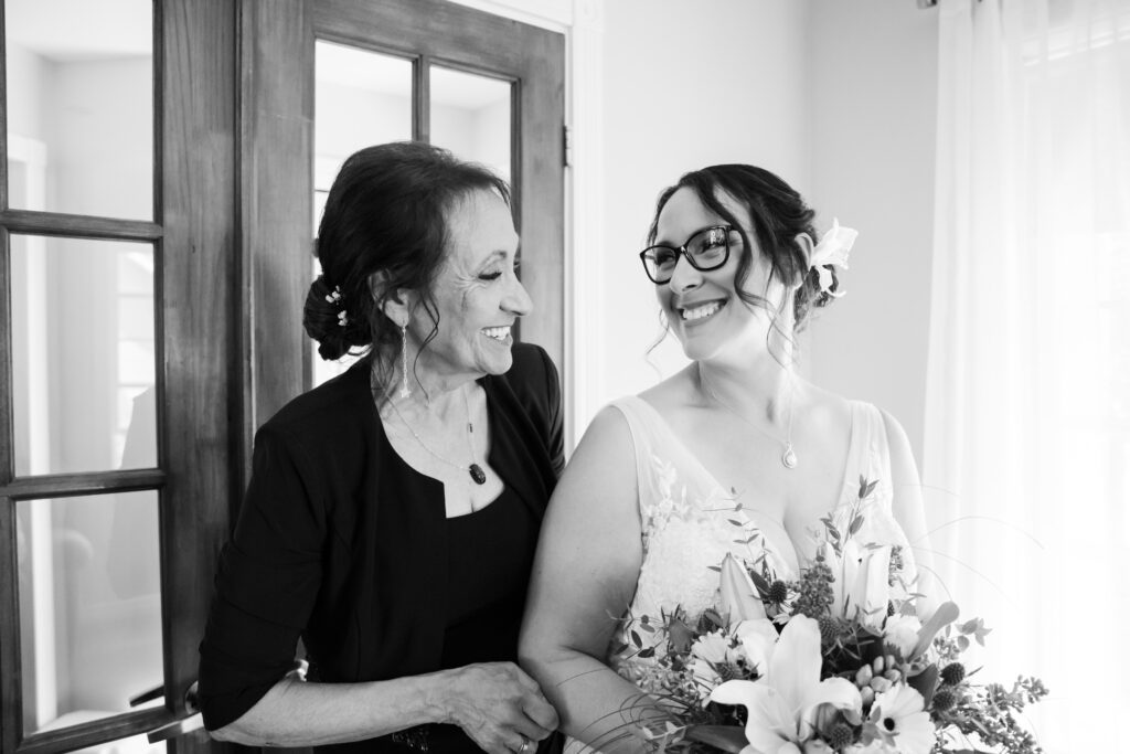 Candid photo of the bride and her mother in black and white