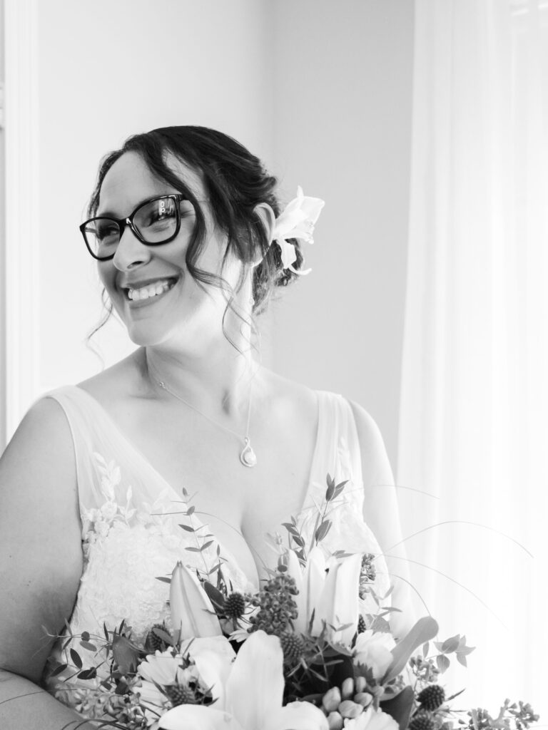 Candid Portrait of a bride on her wedding day with her bouquet in black and white