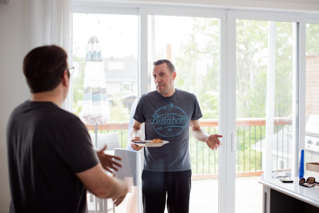 Groomsmen with a plate of pizza before the wedding