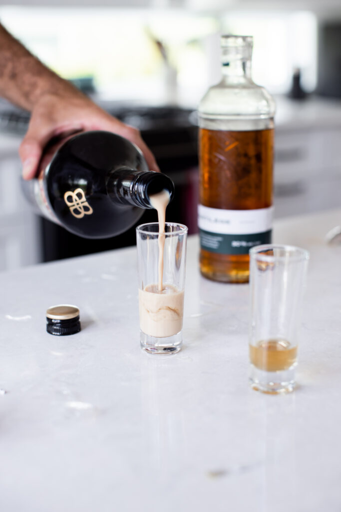 Pouring baileys shots for the groomsmen before the wedding