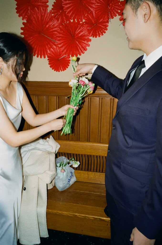 Documentary-style image of the couple waiting outside the clerk’s office inside Cambridge City Hall, taken on 35mm film.