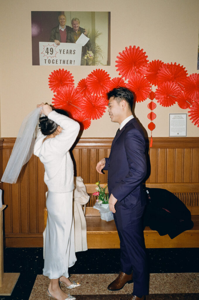 Documentary-style image of the couple waiting outside the clerk’s office inside Cambridge City Hall, taken on 35mm film.