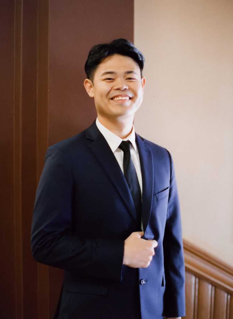 Portrait of Huimin before his Cambridge City Hall elopement, standing confidently in natural morning light, captured on film.