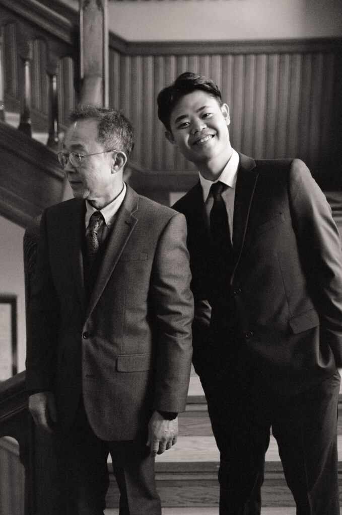 Group portrait of newlyweds Anna and Huimin with both families before their Cambridge City Hall ceremony, captured by a Boston film elopement photographer.
