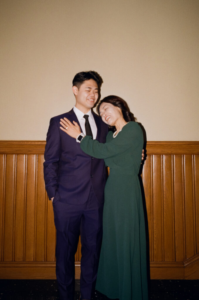 Group portrait of newlyweds Anna and Huimin with both families before their Cambridge City Hall ceremony, captured by a Boston film elopement photographer.