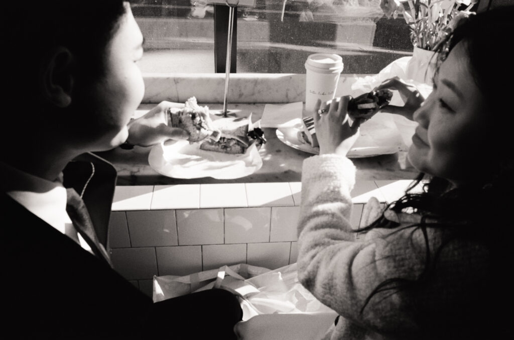 Couple enjoying coffee and pastries together after their Cambridge elopement.
