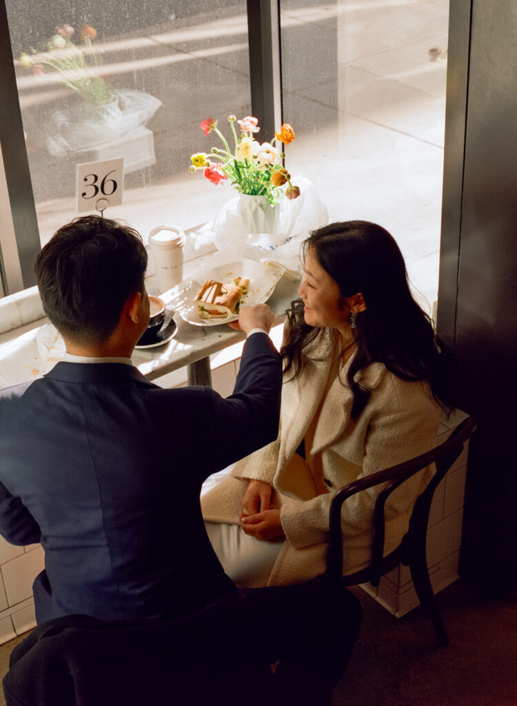 Couple enjoying coffee and pastries together after their Cambridge elopement.