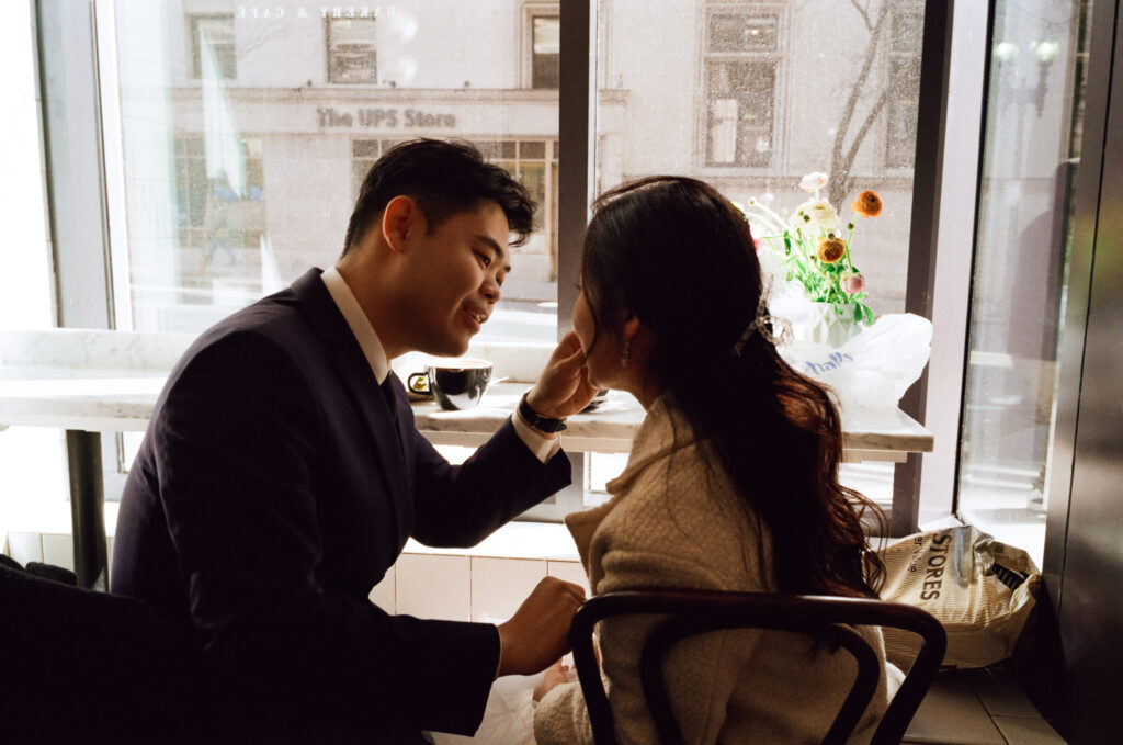 Couple enjoying coffee and pastries together after their Cambridge elopement.
