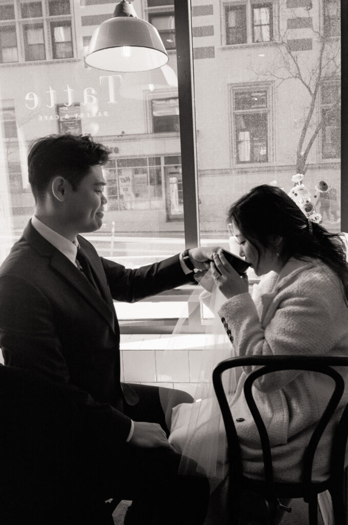 Couple enjoying coffee and pastries together after their Cambridge elopement.