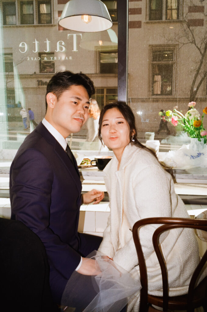 Couple enjoying coffee and pastries together after their Cambridge elopement.