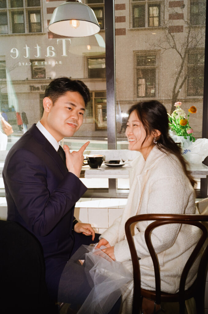 Couple enjoying coffee and pastries together after their Cambridge elopement.