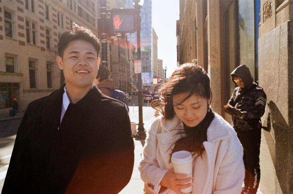 Couple enjoying coffee and pastries together after their Cambridge elopement on film.
