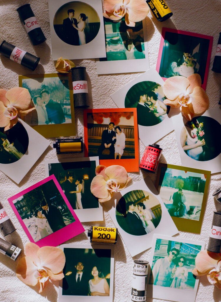 Flat lay image of Polaroids, pink orchids, and 35mm film rolls from a Boston elopement at Cambridge City Hall.