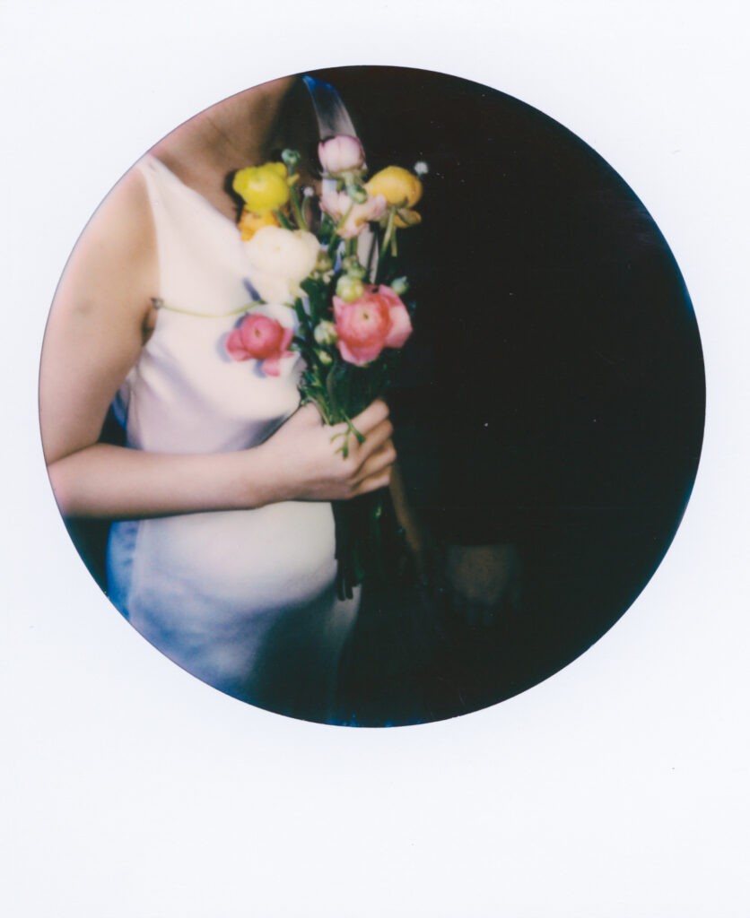 Close-up film photo of Anna’s elopement bouquet with soft pink ranunculus, captured during her Cambridge City Hall elopement by a Boston film photographer.
