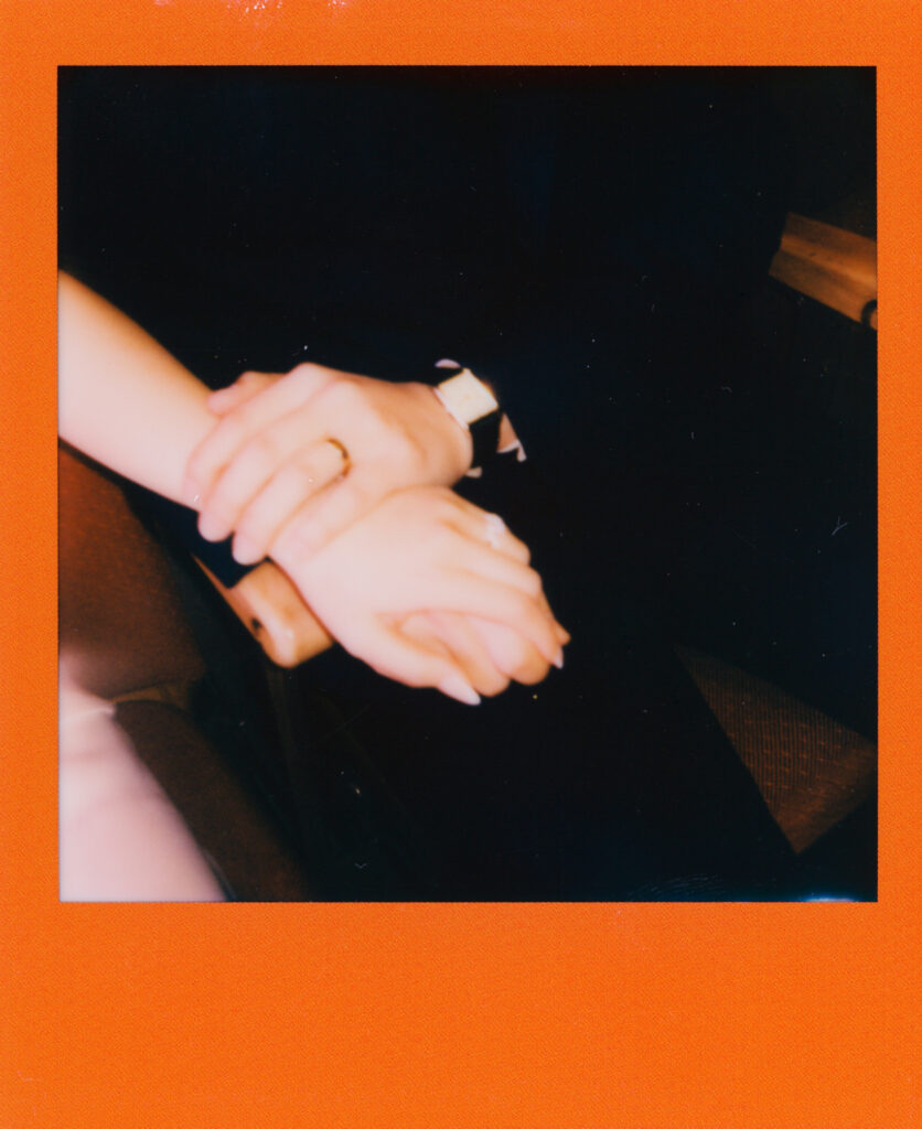 Candid Polaroid of Anna and Huimin smiling and holding hands in the hallway of Cambridge City Hall immediately after their elopement vows.