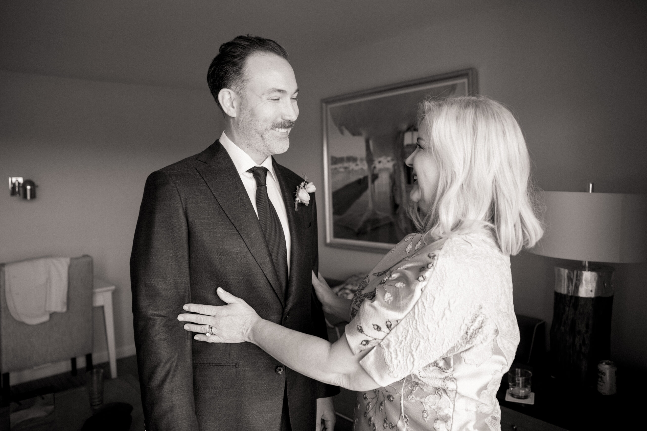 Groom in a dark suit shares a joyful moment with his mother before the Martha’s Vineyard wedding ceremony.