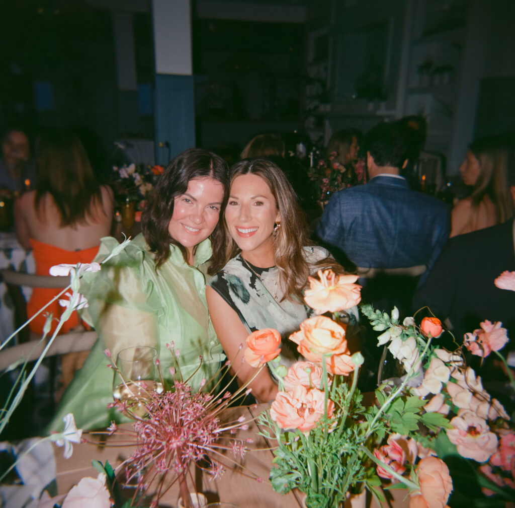 Two women at a table, enjoying each other's company in a friendly and comfortable environment.