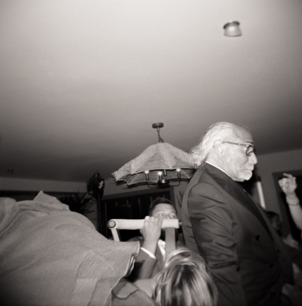 Black and white Holga 120 film flash photo of the bride’s father falling off the chair during the hora at a Martha’s Vineyard wedding, a candid and humorous Jewish wedding tradition moment.