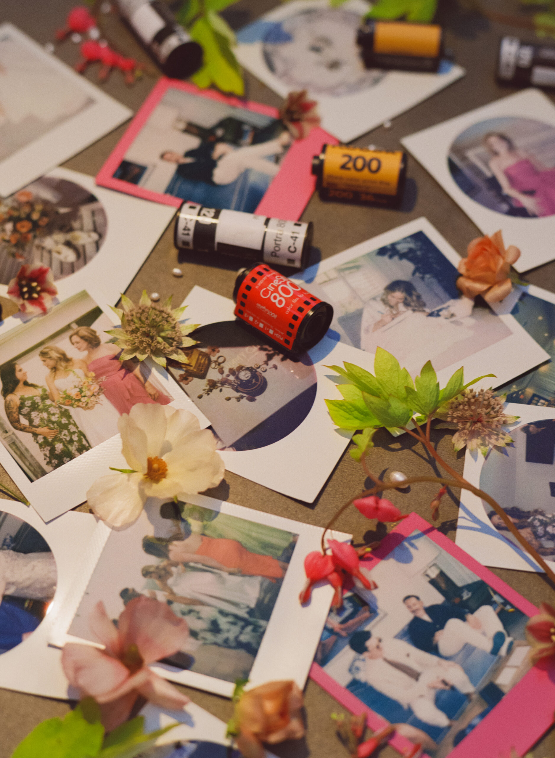 Polaroid wedding flatlay with fresh flowers and 35mm film canisters, featuring candid guest moments captured on analog film.