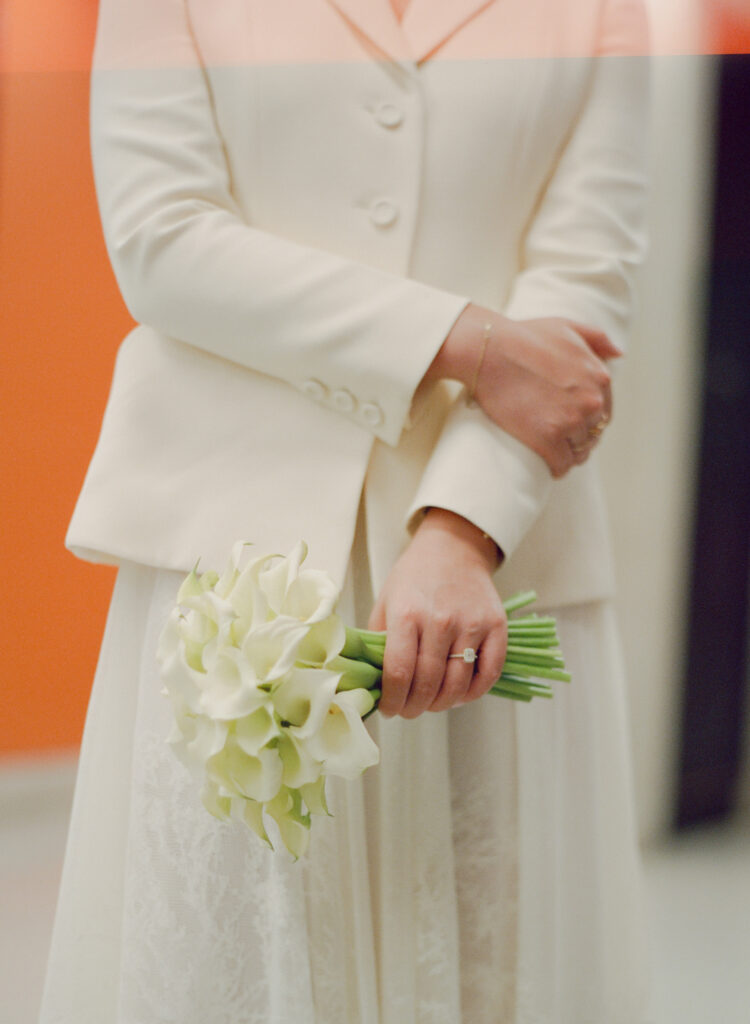 Close up detail photo of the bride holding her bouquet of Calla Lily's, showing off her engagement ring at Boston City Hall