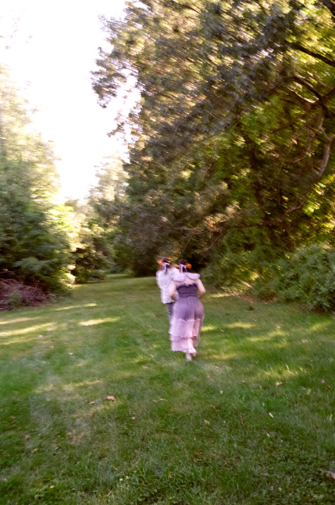 Blurry photograph of a couple on their wedding day in their full attire walking away. 