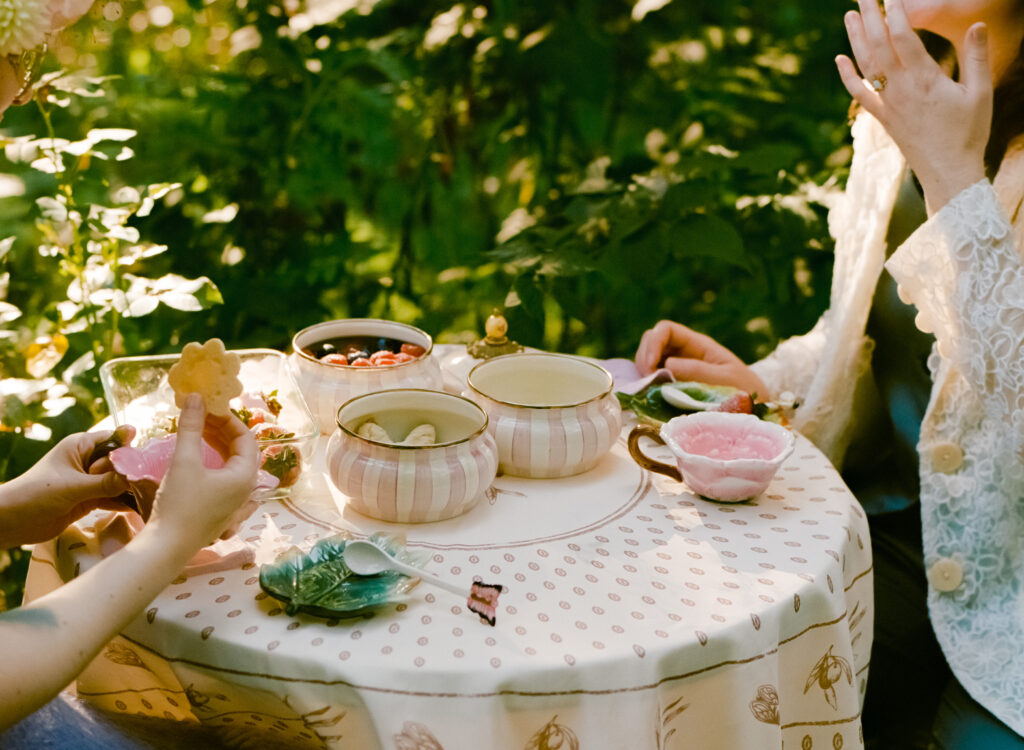 Detail shot of the set table, which is accompanied by nature-themed ceramics and treats.