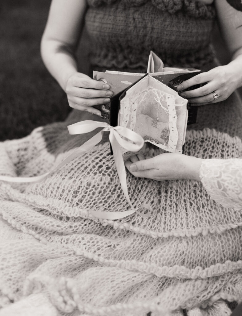 Black and white photograph of a carousel book open, recreating the shape of a star.