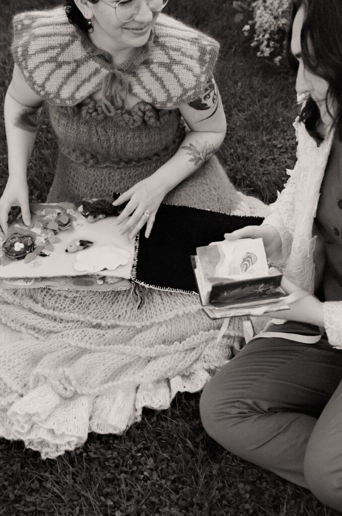 Black and white photograph of the newlywed couple going through their respective gifts to one another in the form of handmade books.